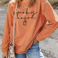 Orange ribbed pullover sweatshirt with spooky “sprooky season” graphic and long sleeves