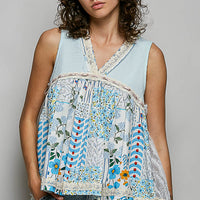 Light blue floral sheer V-neck tank with lace-trim neckline and hem.