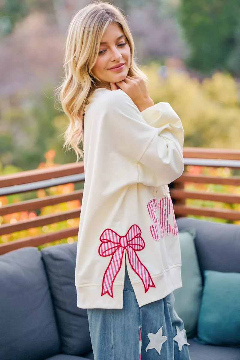 Cream sweatshirt with red bow patch and red/blue stars-and-stripes print