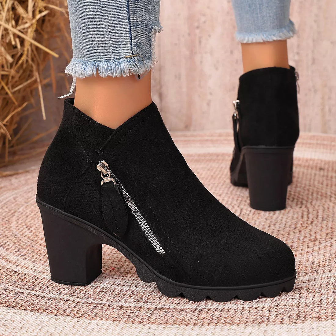Black suede ankle boots with round toe, block heel, and side zipper detail