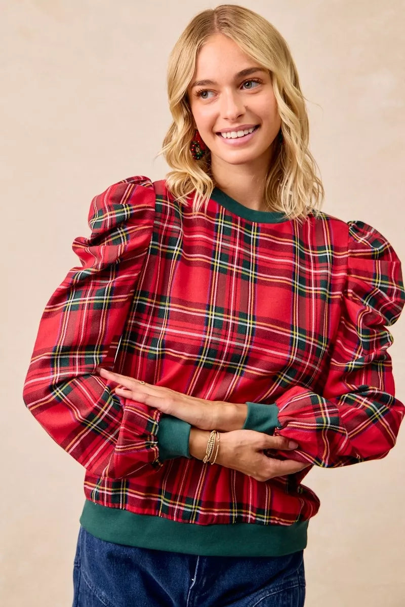 Red plaid top with puff shoulders and green crew neck, long sleeves