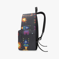Kids canvas backpack, black with pixel-game graphics and top carry handle.