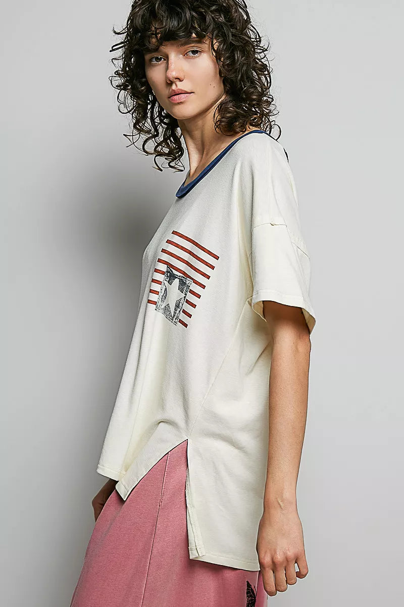 Cream cotton top with American flag graphic and loose short sleeves, angled side view