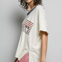 Cream cotton top with American flag graphic and loose short sleeves, angled side view