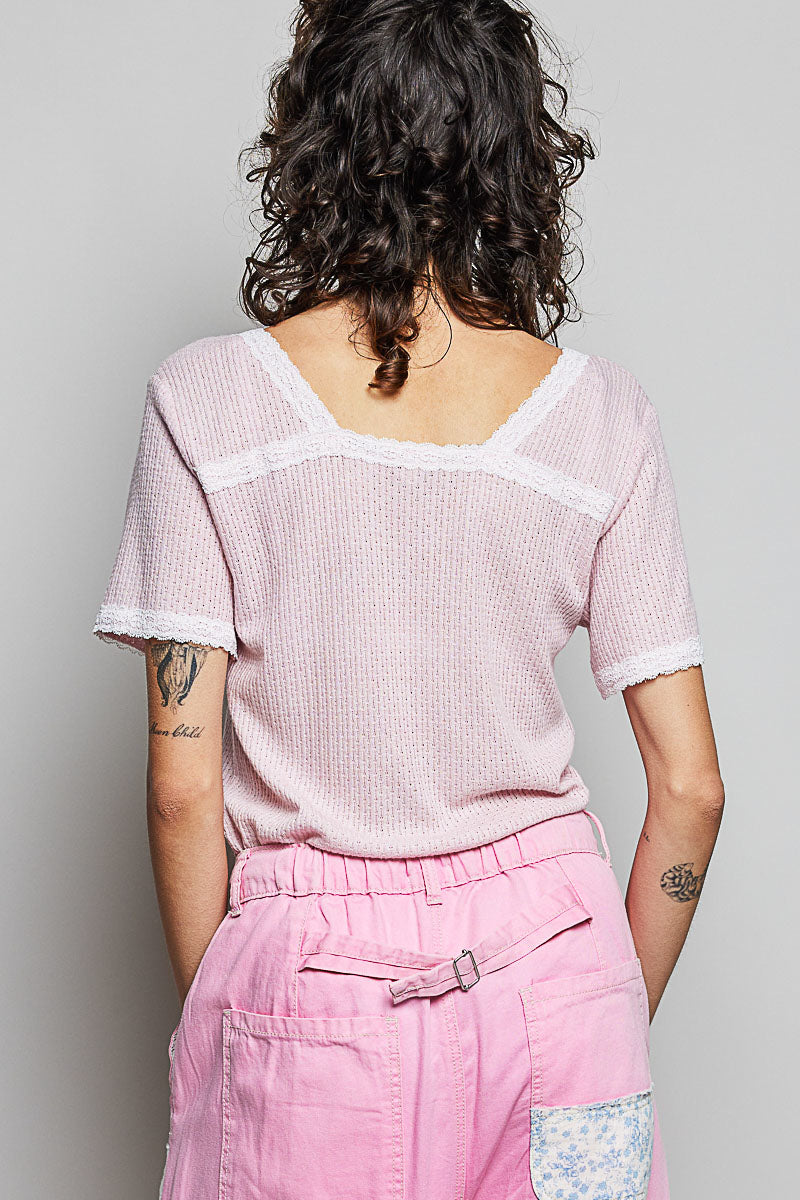 Baby pink textured short-sleeve T-shirt with white lace trim at back neckline