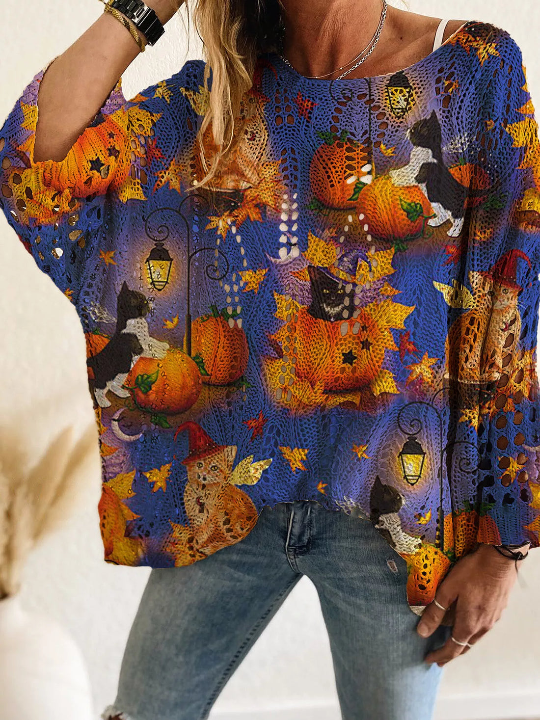 Plus size loose knit cover-up with blue and purple pumpkin print and festive Halloween motifs.