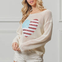 Off-white knit sweater featuring American flag heart sequin design, long sleeves.