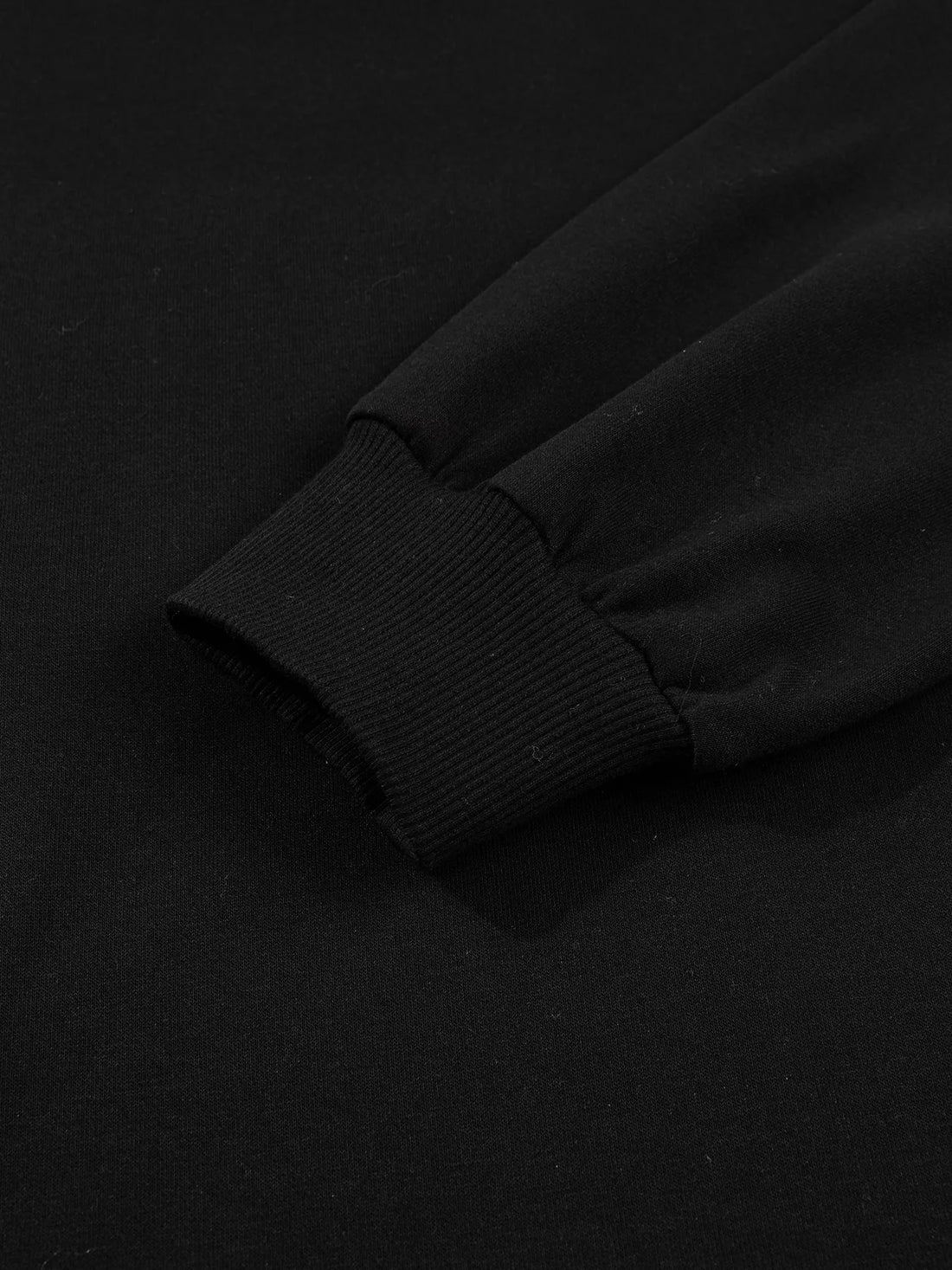 Black sweatshirt sleeve cuff ribbing close-up