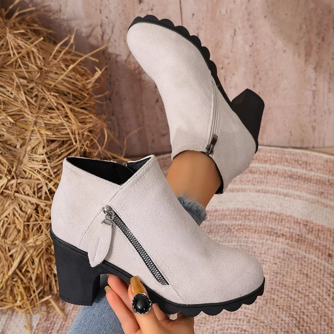 Light beige suede ankle boots with round toe, block heel, and side zipper