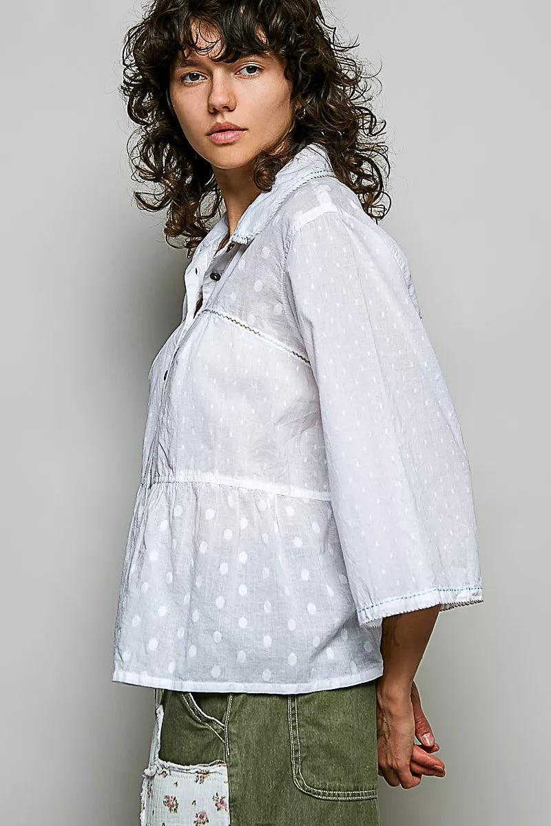 Off-white button-front shirt, tonal dot pattern, three-quarter side view