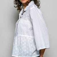 Off-white button-front shirt, tonal dot pattern, three-quarter side view