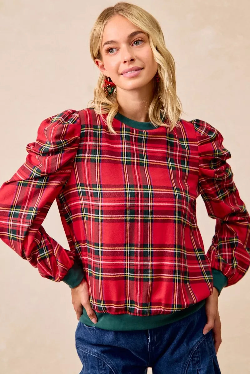 Red plaid top with exaggerated shoulders, balloon sleeves, and green ribbed hem