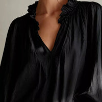 Black ruffle-trim blouse with V-neck and shoulder ruffle detailing