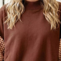 Dark brown loose tunic sweatshirt with ribbed crew neck and plaid check sleeve