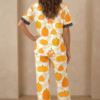 Back view of pumpkin print lounge pajama set with polka-dot trim at collar and cuffs