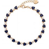 Gold-tone tennis bracelet with blue faceted stones and small heart charm tag