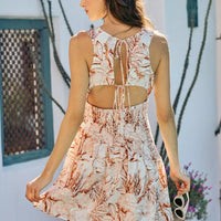 Back and side view of lined mini dress with coral-brown shell print, smocked bodice