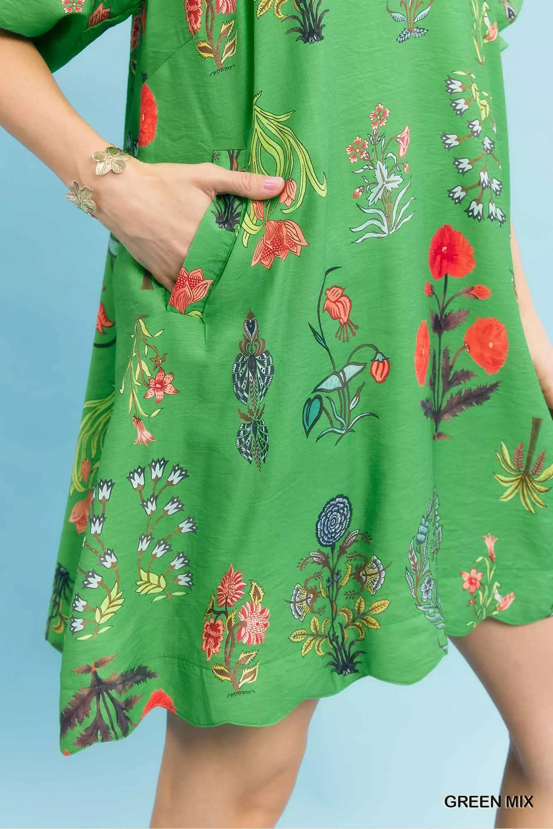 Green floral mini dress fabric detail with colorful flowers and plants print