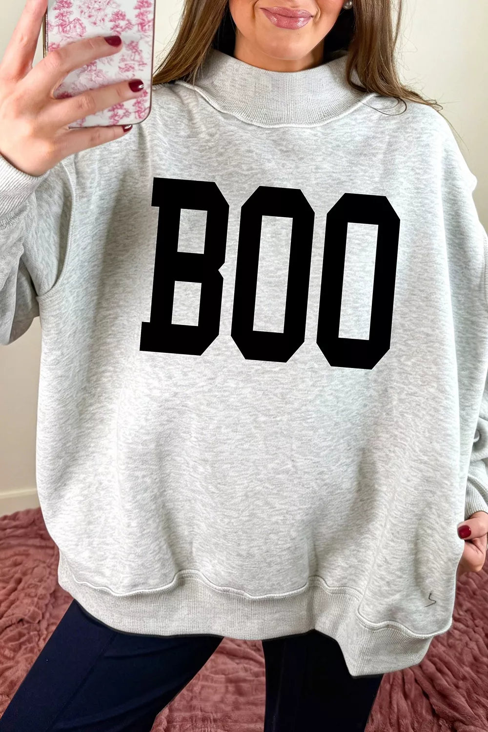 Light gray reversible mock-neck sweatshirt with large black “BOO” front graphic