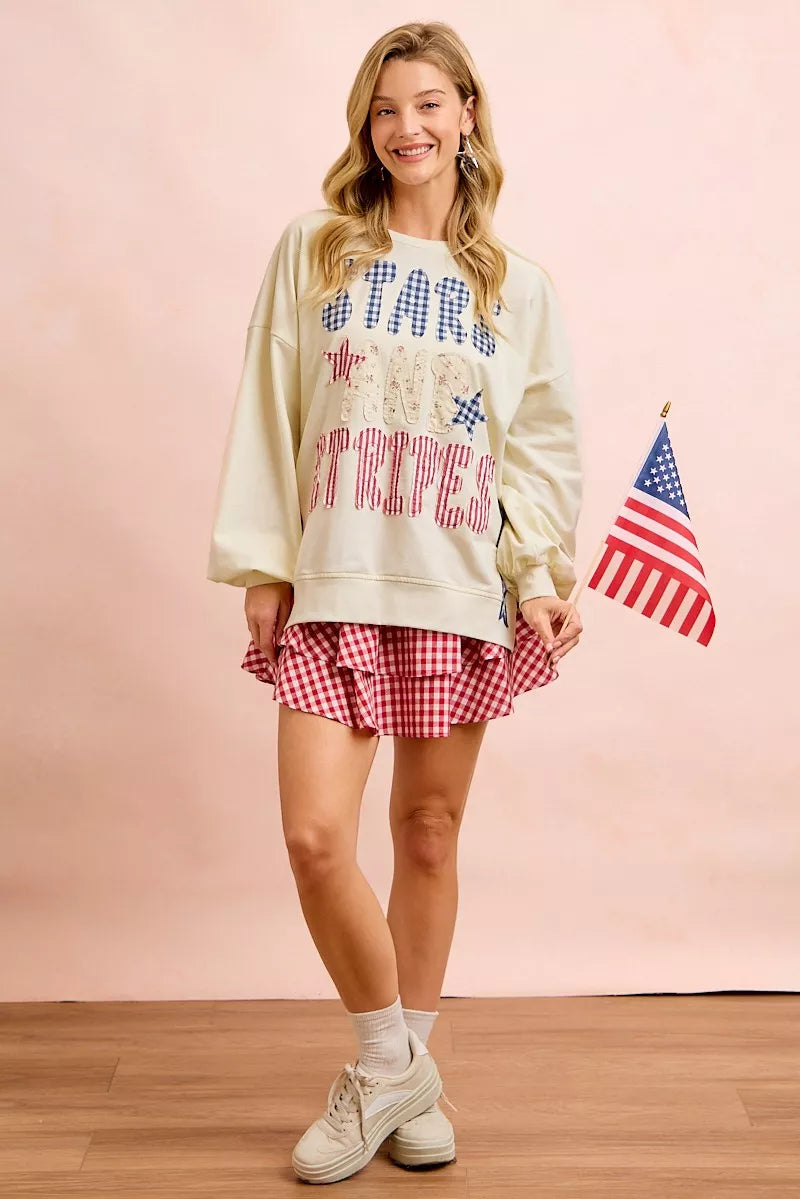 Cream sweatshirt with stars-and-stripes graphic, patch-style print, long sleeves