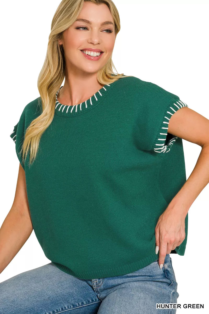 Hunter green oversize knit sweater with contrasting stitch trim at neckline and sleeve hems