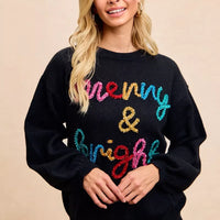 Black Christmas sweater with multicolor tinsel-style "Merry & Bright" lettering on chest