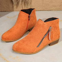 Orange suede point-toe block heel ankle boots with side zipper and rounded toe