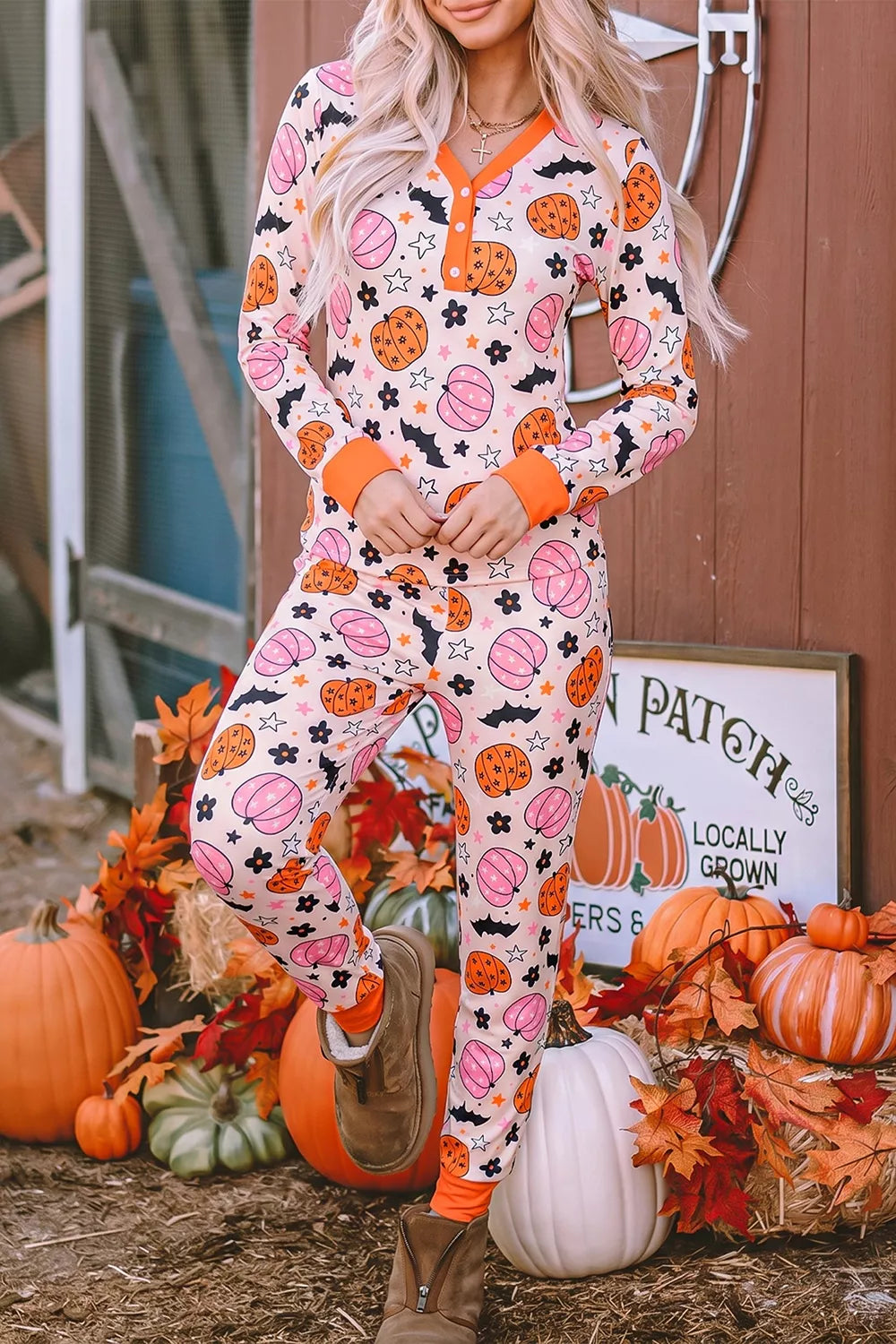 Dusty pink pumpkin-print long-sleeve lounge set with orange-trim buttons and cuffed pants