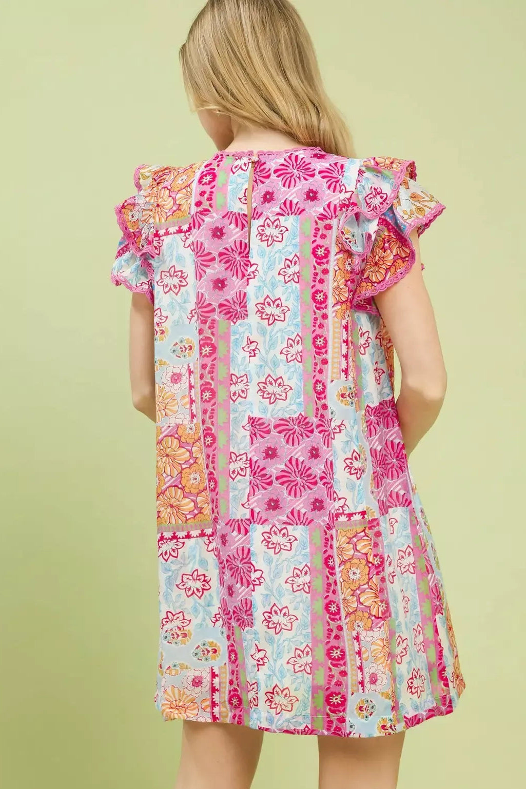 Back view pink patchwork mini dress with flutter sleeves and panel stitching