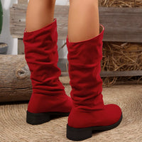 Red round-toe block heel boots with ruched knee-high shaft, rear view