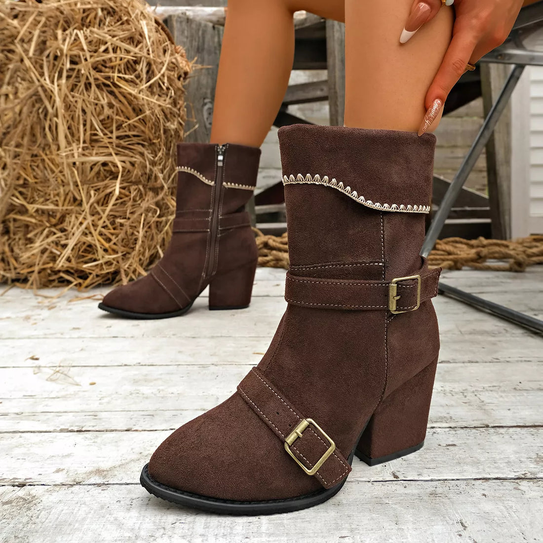 Brown suede ankle boots with block heel, point toe, buckled straps, side zipper.