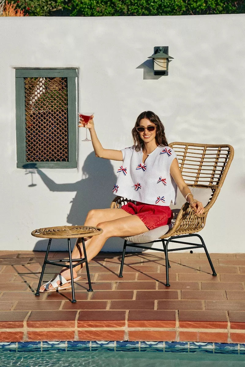 Off-white dolman sweater with red, white, and blue ribbon bow embellishments