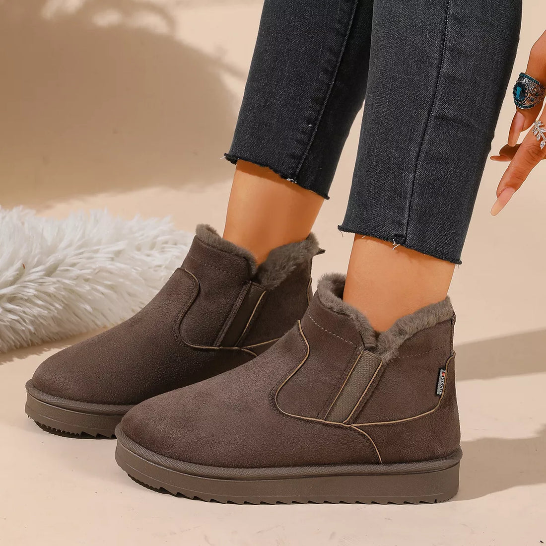 Dark brown plush-lined ankle boots with side elastic panels and thick sole