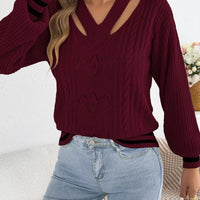 Burgundy cable knit sweater with cutout shoulders, V-neck and ribbed hem