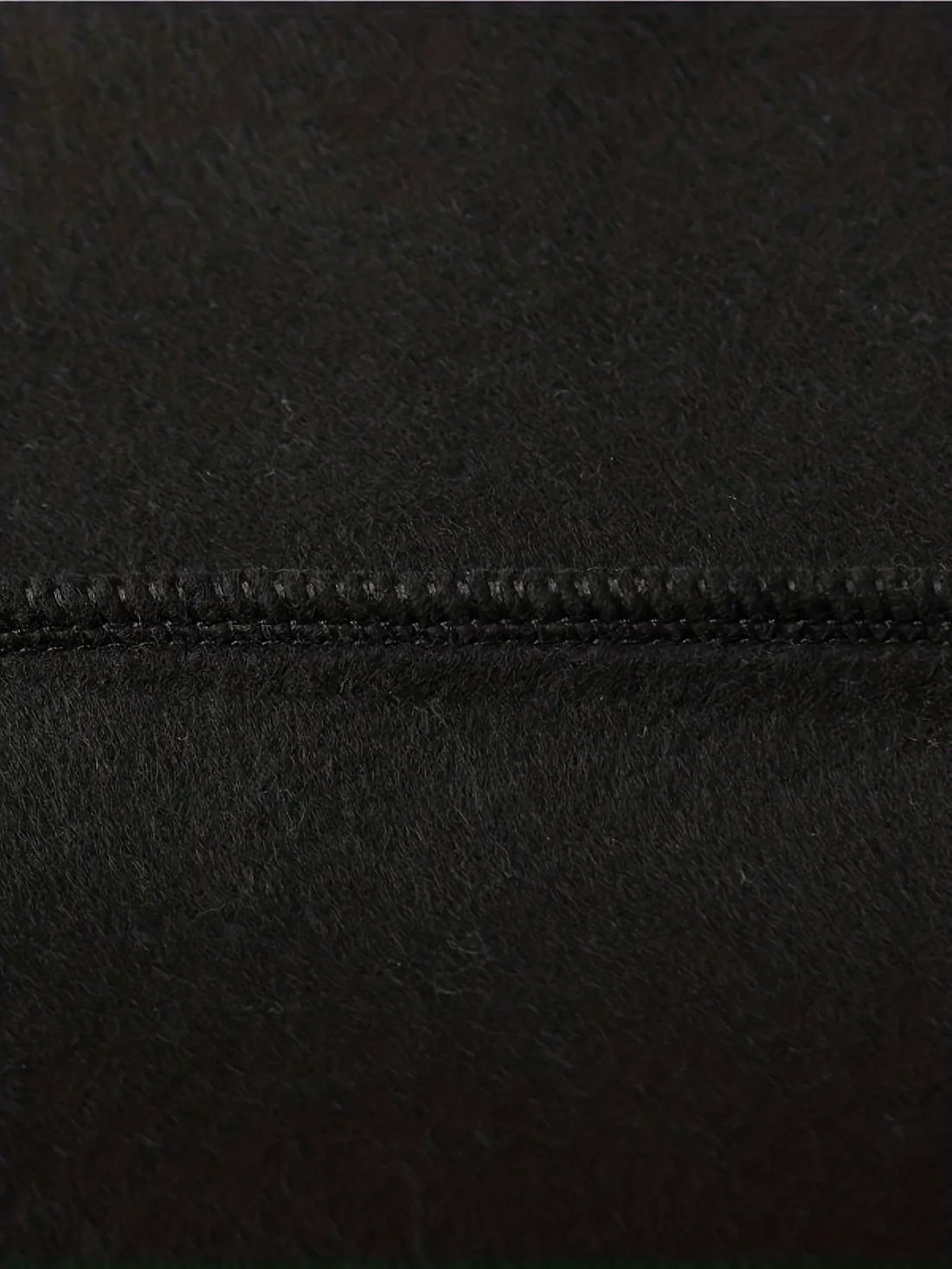 Black hoodie seam close-up with neat stitched edging