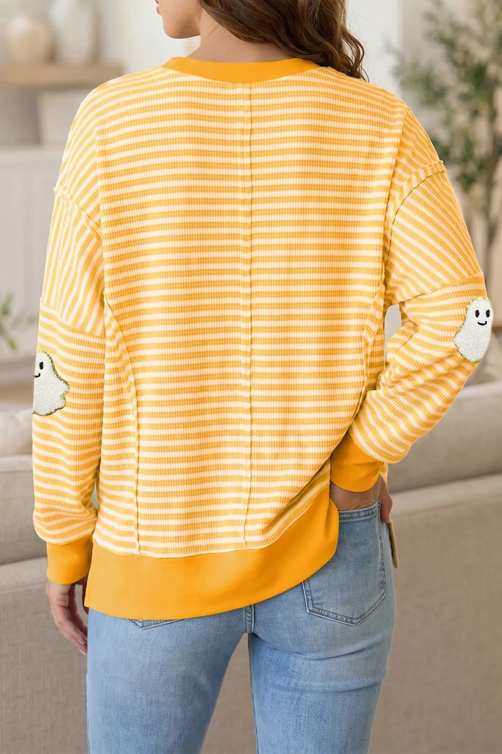 Yellow and white striped long-sleeve top, round neck, back view