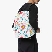 Kids small backpack on person: colorful doodle rainbow print canvas with black side panels