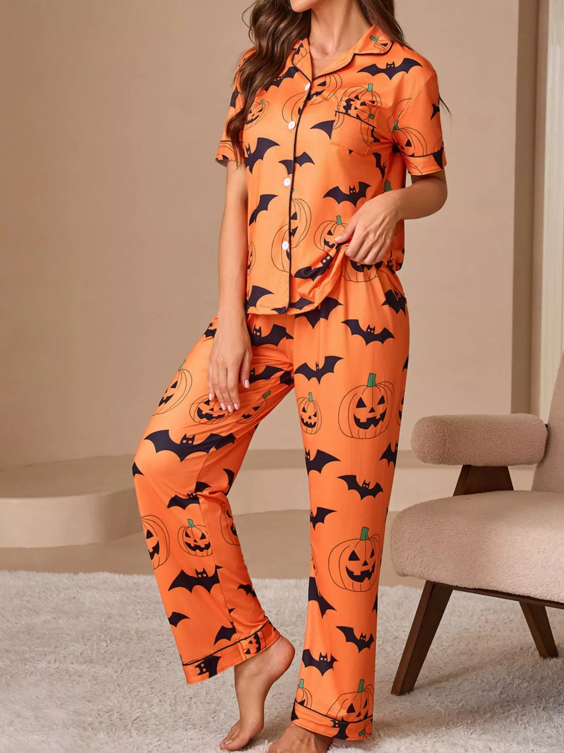 Orange Halloween pajama lounge set with pumpkin and bat print, button-front short-sleeve top