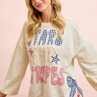 Cream sweatshirt with blue star top, red stripe lettering, and bow patch on right side.