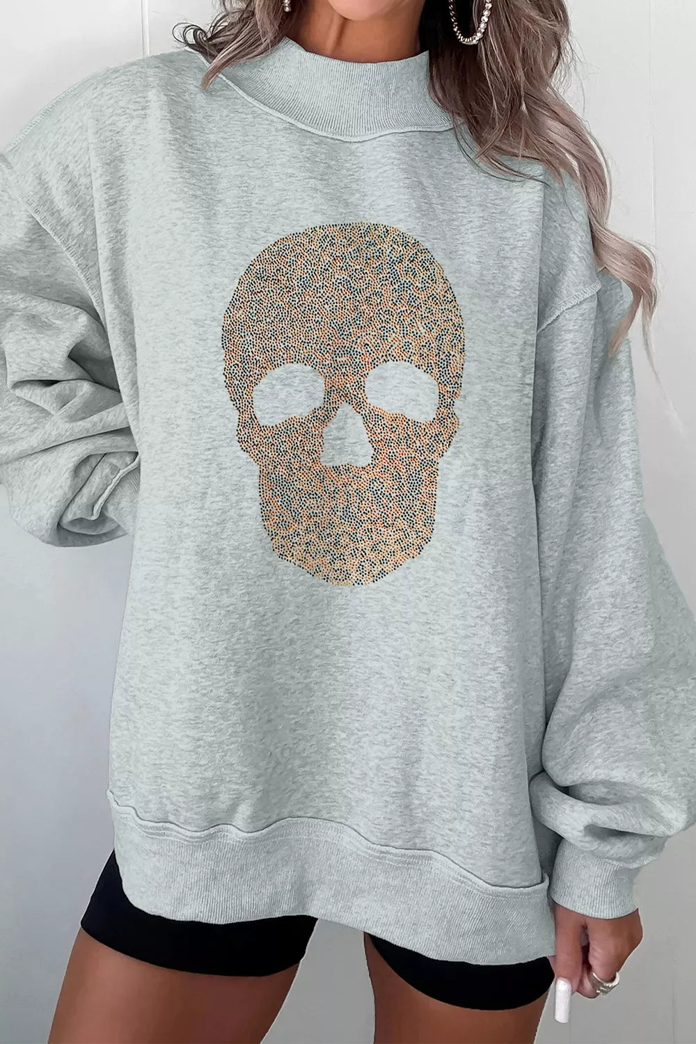 Gray mock-neck pullover sweatshirt with glitter skull graphic on the front