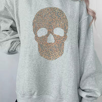 Gray mock-neck pullover sweatshirt with glitter skull graphic on the front