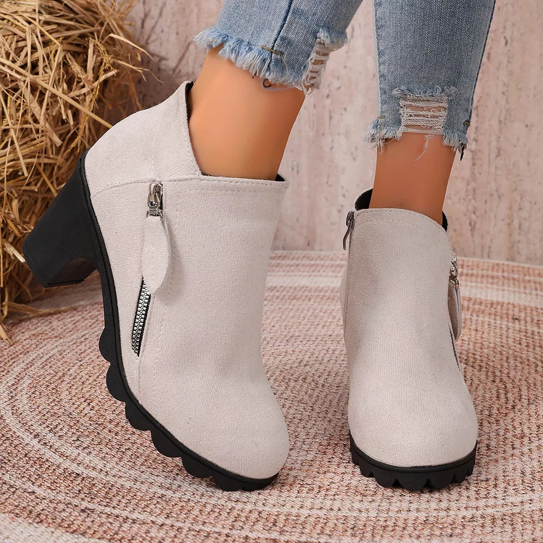 Beige suede ankle boots with round toe, block heel, and side zipper closure