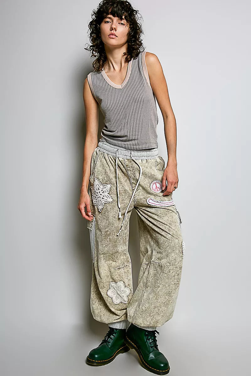 Light grey ribbed V-neck sleeveless tank with contrast trim, full-body model view.