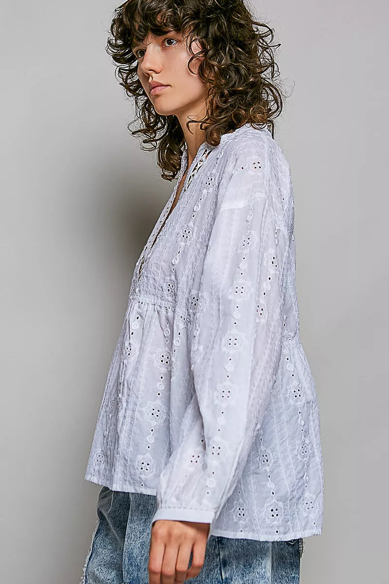 Off-white long-sleeve eyelet blouse with V-neck and gathered, flowy hem