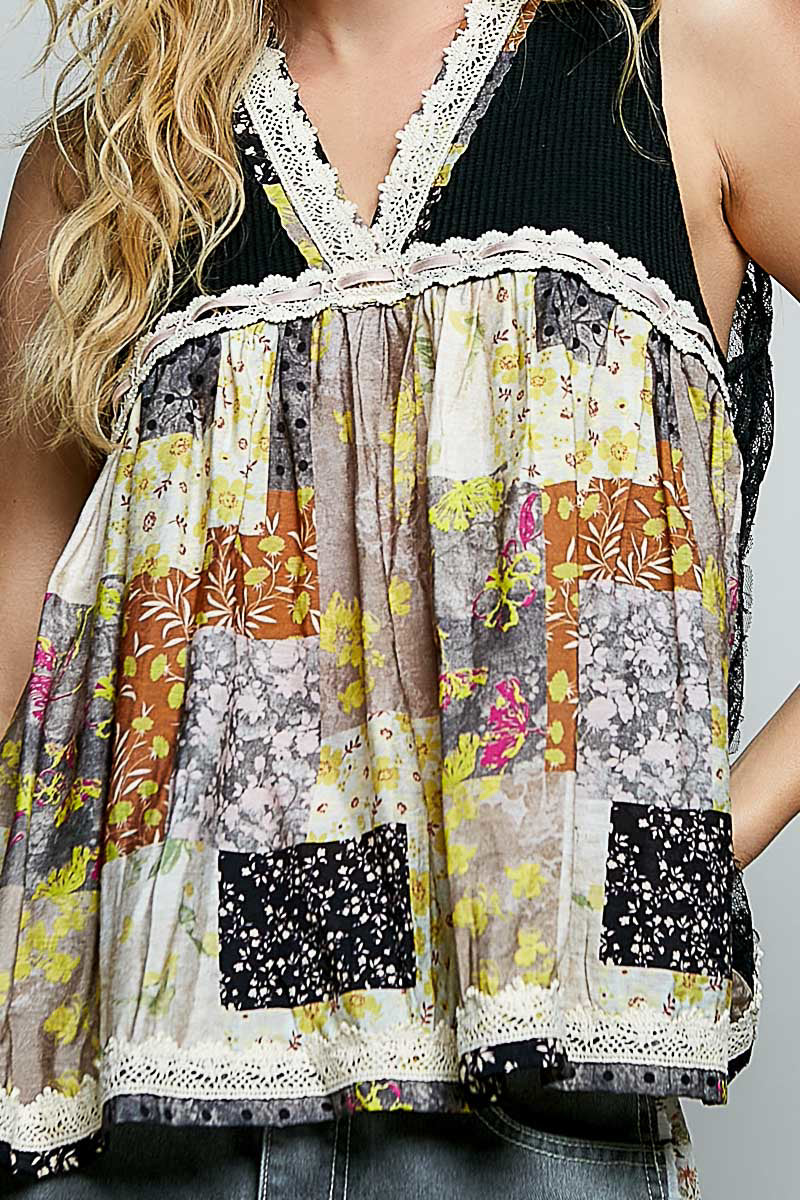 Close-up: black sheer floral V-neck tank with white lace trim and patchwork print