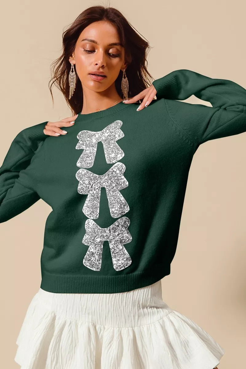 Hunter-green Christmas sweater with vertical silver sequin bow ribbon embellishment