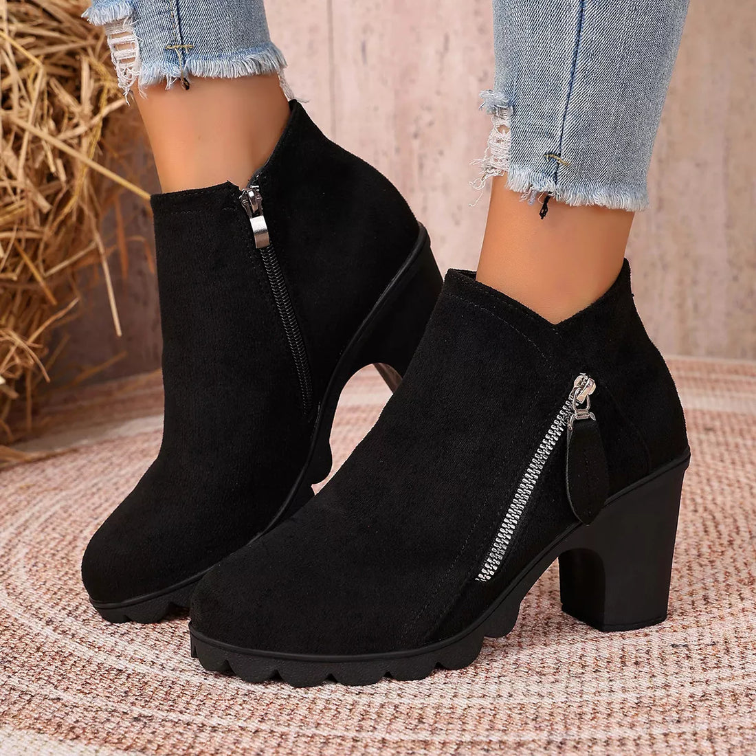 Black suede ankle boots with round toe, block heel, and side zipper closure