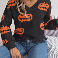 Black knit V-neck sweater with orange jack-o’-lantern pattern and frayed distressed hem