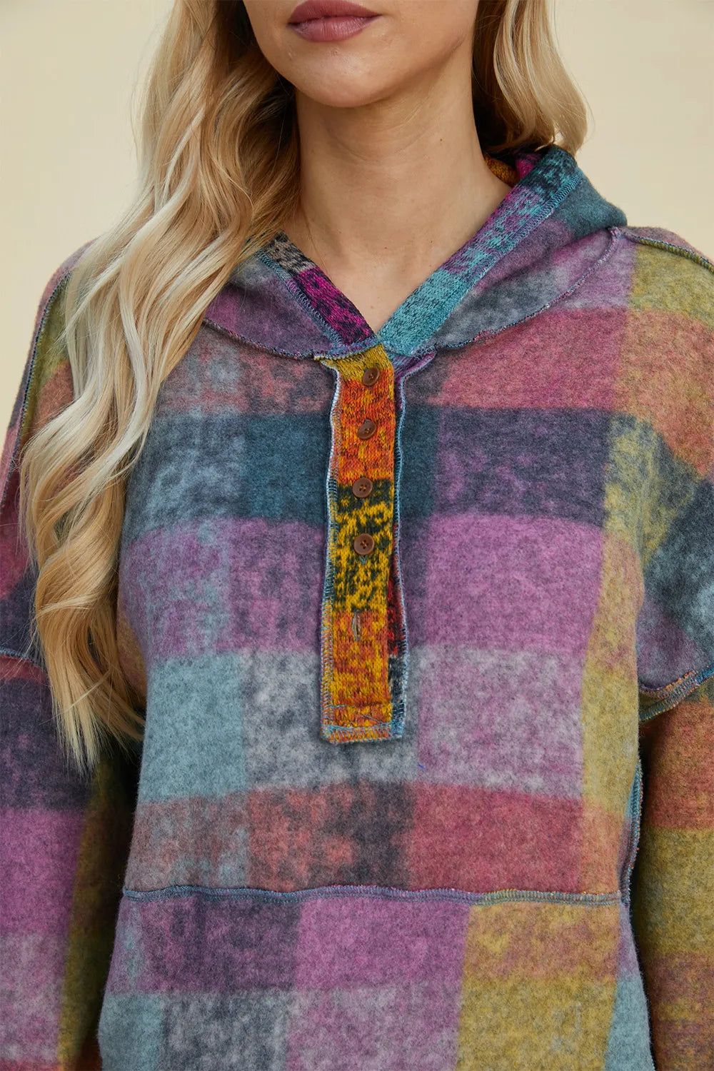 Close-up of multicolor plaid fleece hoodie hood and front button placket