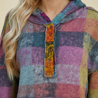 Close-up of multicolor plaid fleece hoodie hood and front button placket